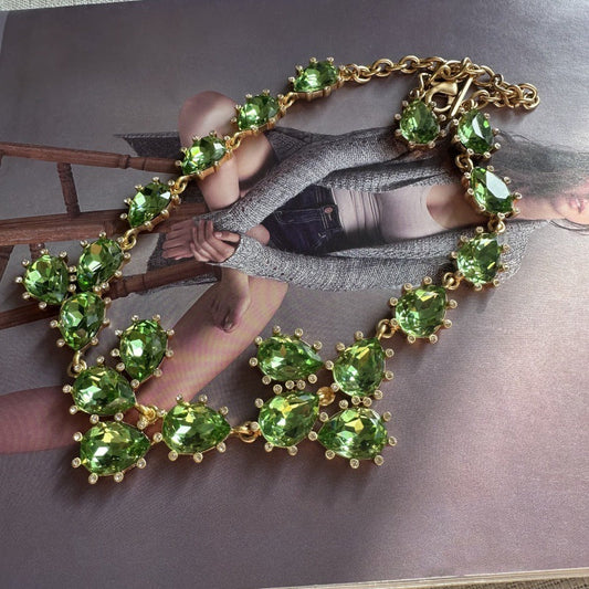 Gold-tone crystal necklace with green teardrop stones and linked chain