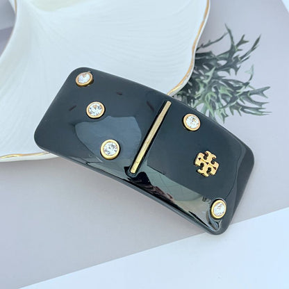 Tory Burch Haarklammer rechteckig schwarz mit Strass und Diamant-Logo