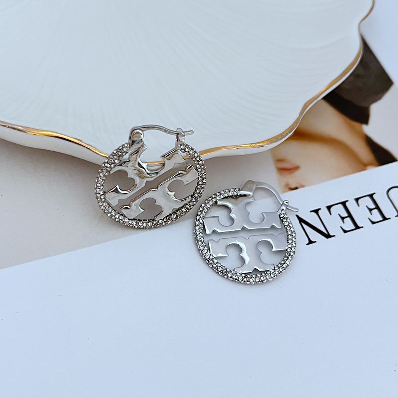 Tory Burch rhinestone openwork metal hoop earrings, silver-tone, front view of cutout pattern