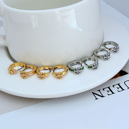 Geometric hoop earrings with gold and silver tones, green and pink enamel accents