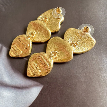 Gold-plated leaf pendant earrings with gold-tone enamel heart shapes and stud posts