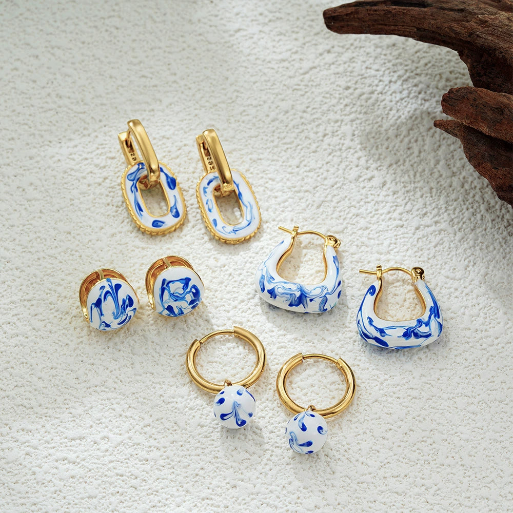 Assorted gold-tone blue marble earrings: small hoops and oval drops