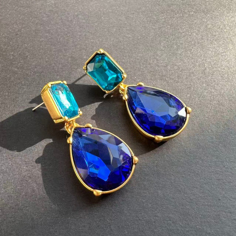 Gold teardrop-cut stud earrings with blue and teal gemstone drops and studs