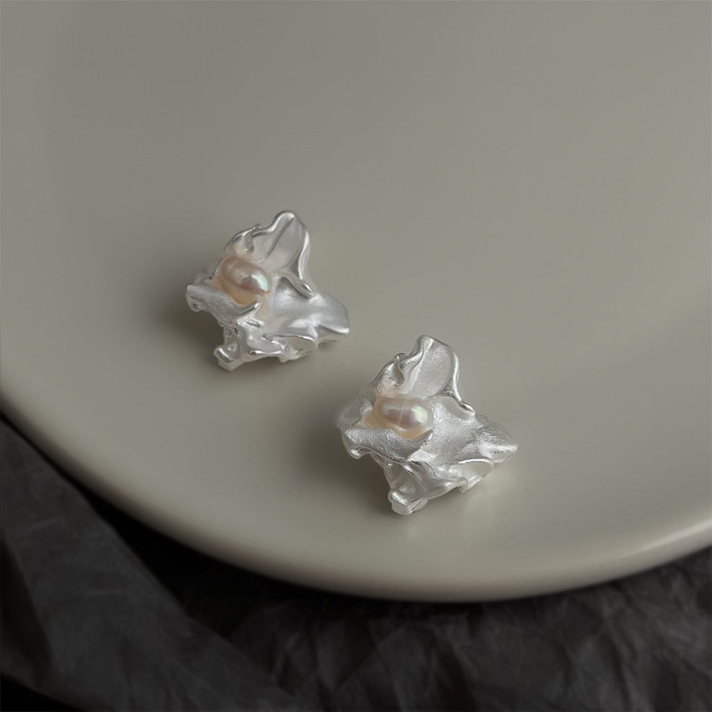Silver irregular freshwater pearl stud earrings with petal-like settings