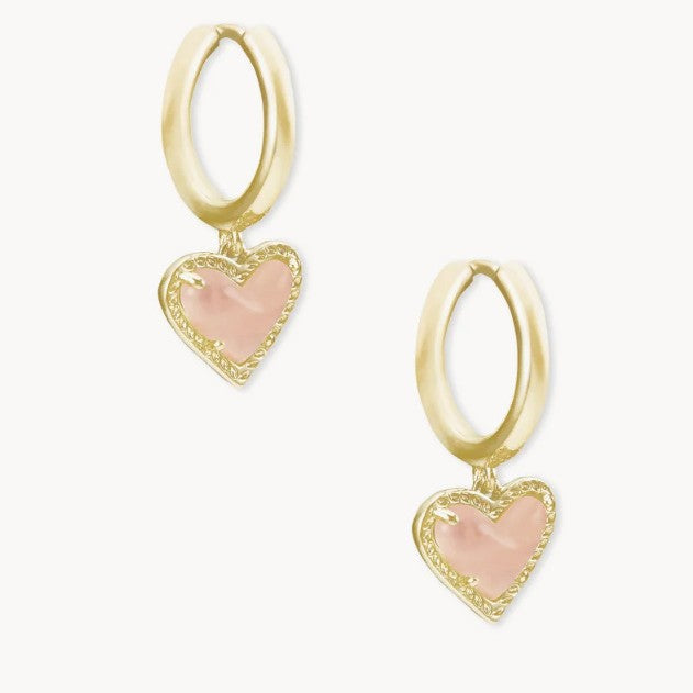 Gold heart pendant hoop earrings with pale pink stone and heart bezel detail