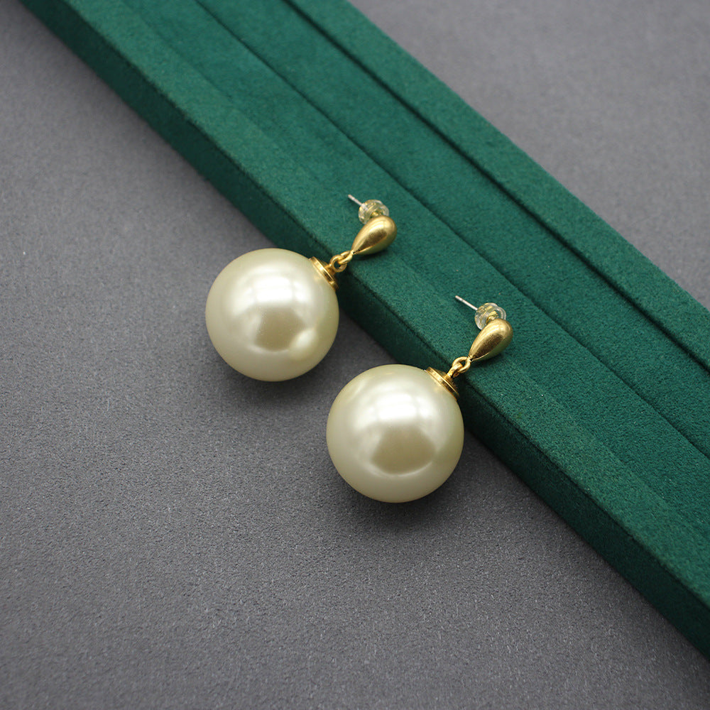 Gold faux-pearl drop earrings with large ivory spheres and hoop connectors