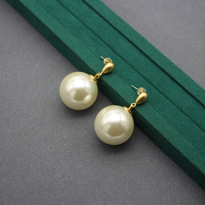 Gold faux-pearl drop earrings with large ivory spheres and hoop connectors