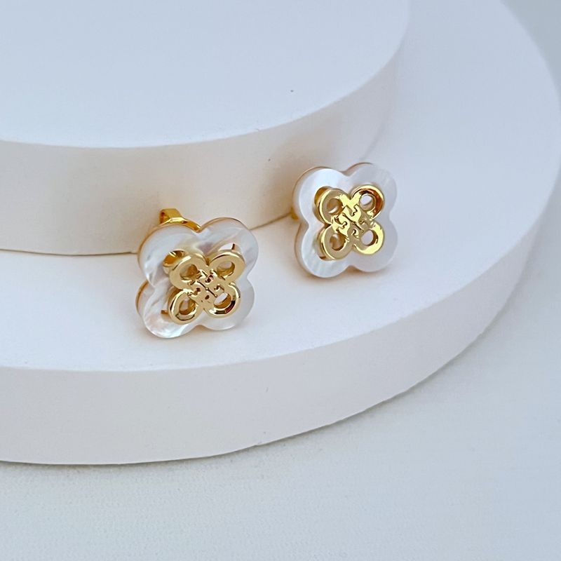 White openwork clover flower stud earrings with gold-tone filigree, round backs