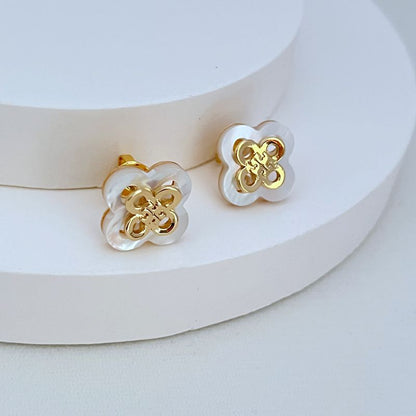 White openwork clover flower stud earrings with gold-tone filigree, round backs