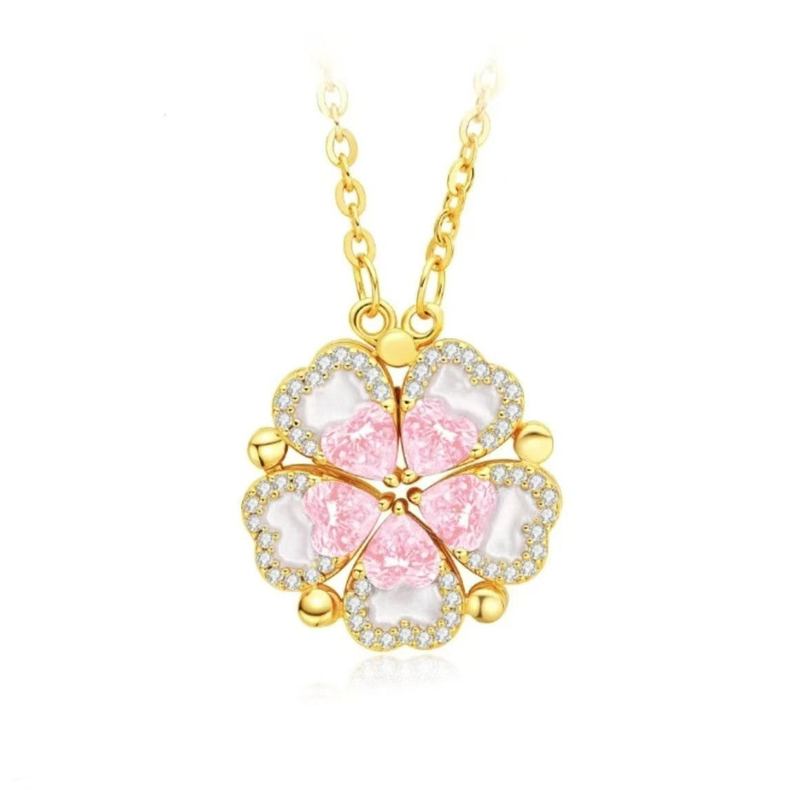 Gold-tone four-leaf clover necklace pendant with pink inlays and sparkling clear stones