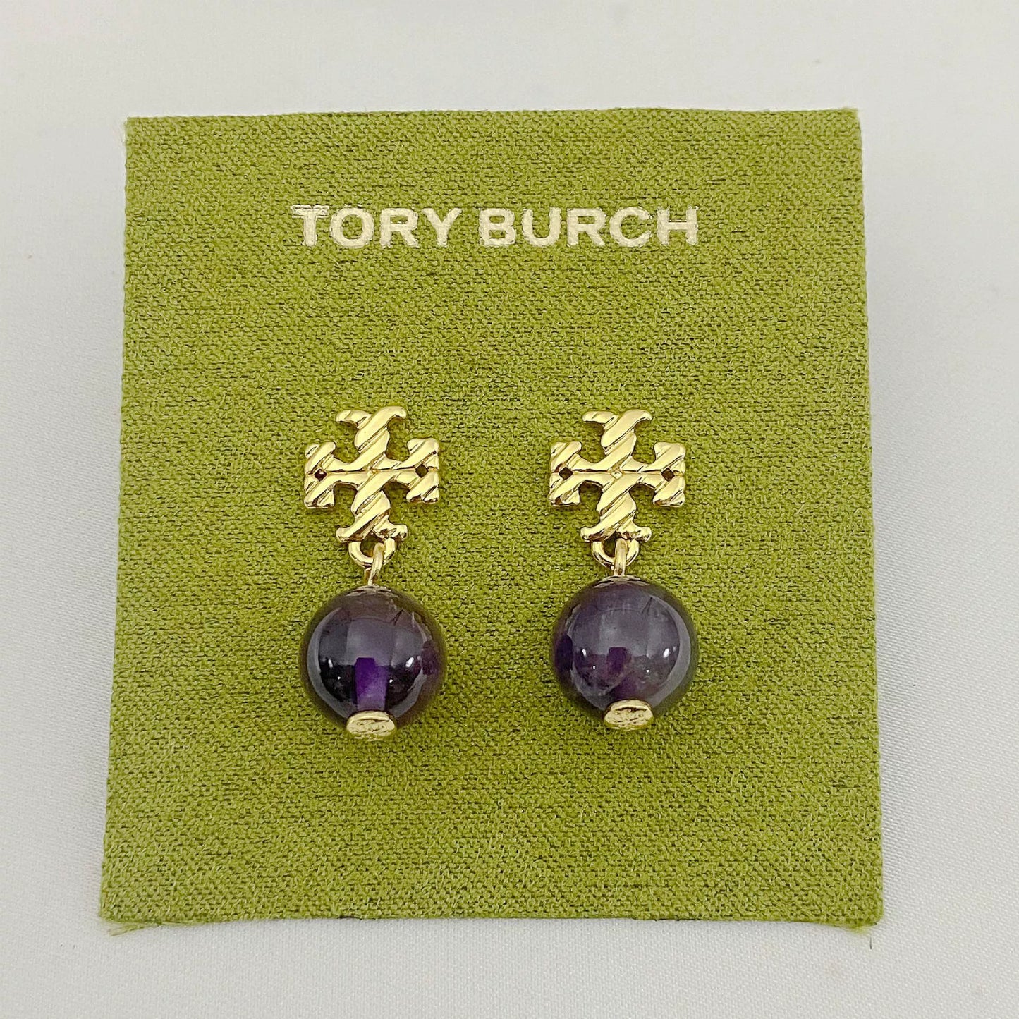 Gold-tone agate pendant earrings with round purple stones and leaf-like top motif