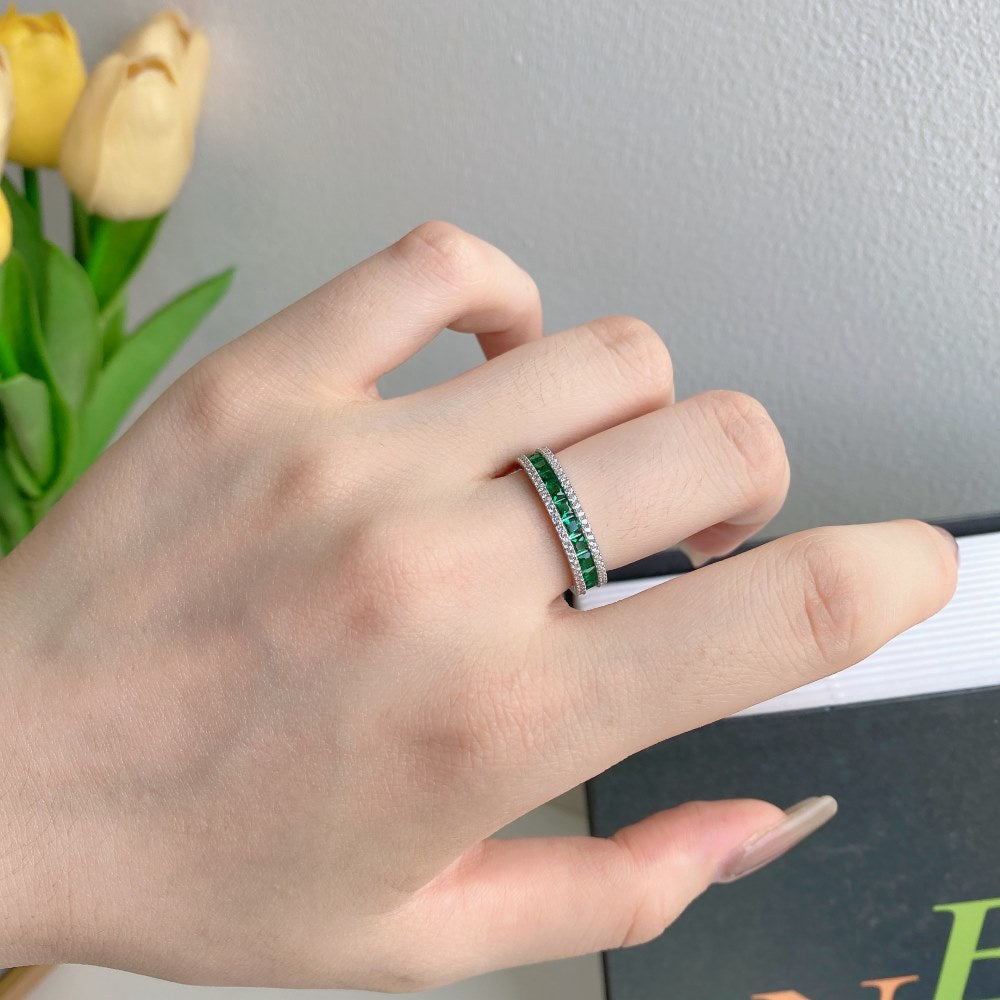 Sterling silver diamond band ring on hand, green stones with clear outer pavé