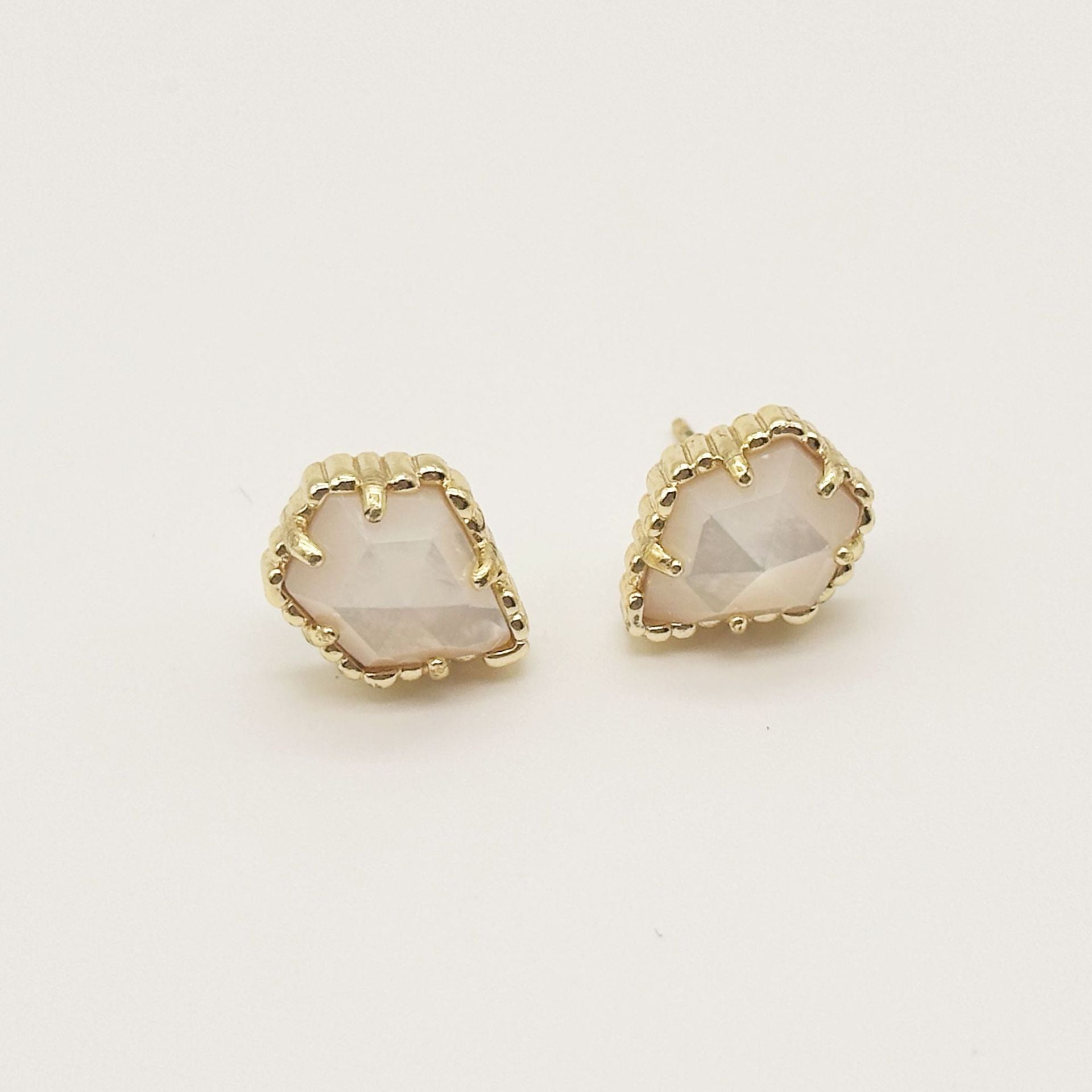 Irregular rhombus stud earrings with iridescent light stone and gold-tone scalloped bezel