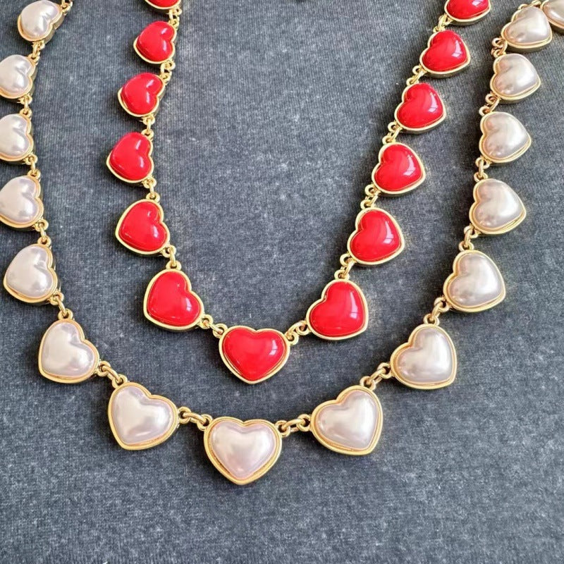 Red heart-shaped necklace with gold chain and smooth 3D heart charms