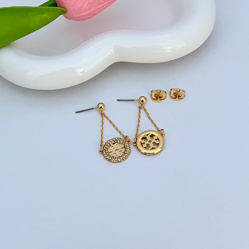 Gold hoop drop earrings with round pavé rhinestone charm and visible post backs