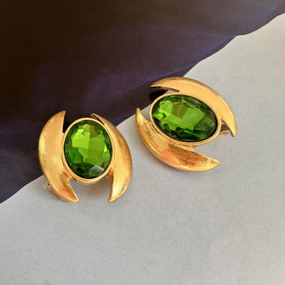 Gold-tone oval crystal stud earrings with green faceted stones