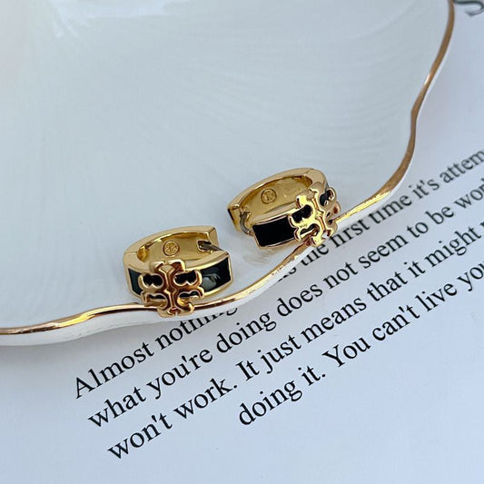 Enamel logo metal earrings with black and gold-tone detailing, hoop style