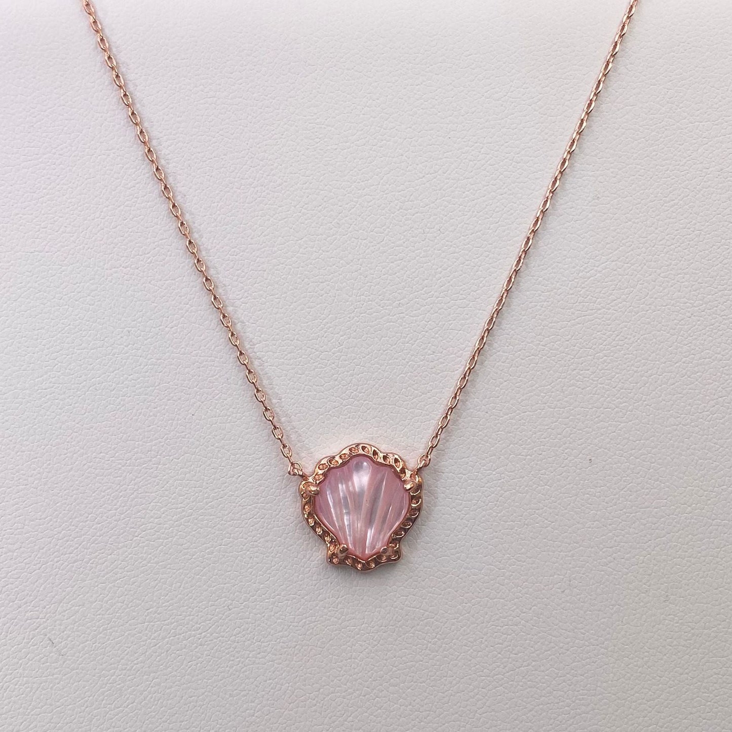 Rose gold-tone scallop pendant necklace with pink mother-of-pearl shell center