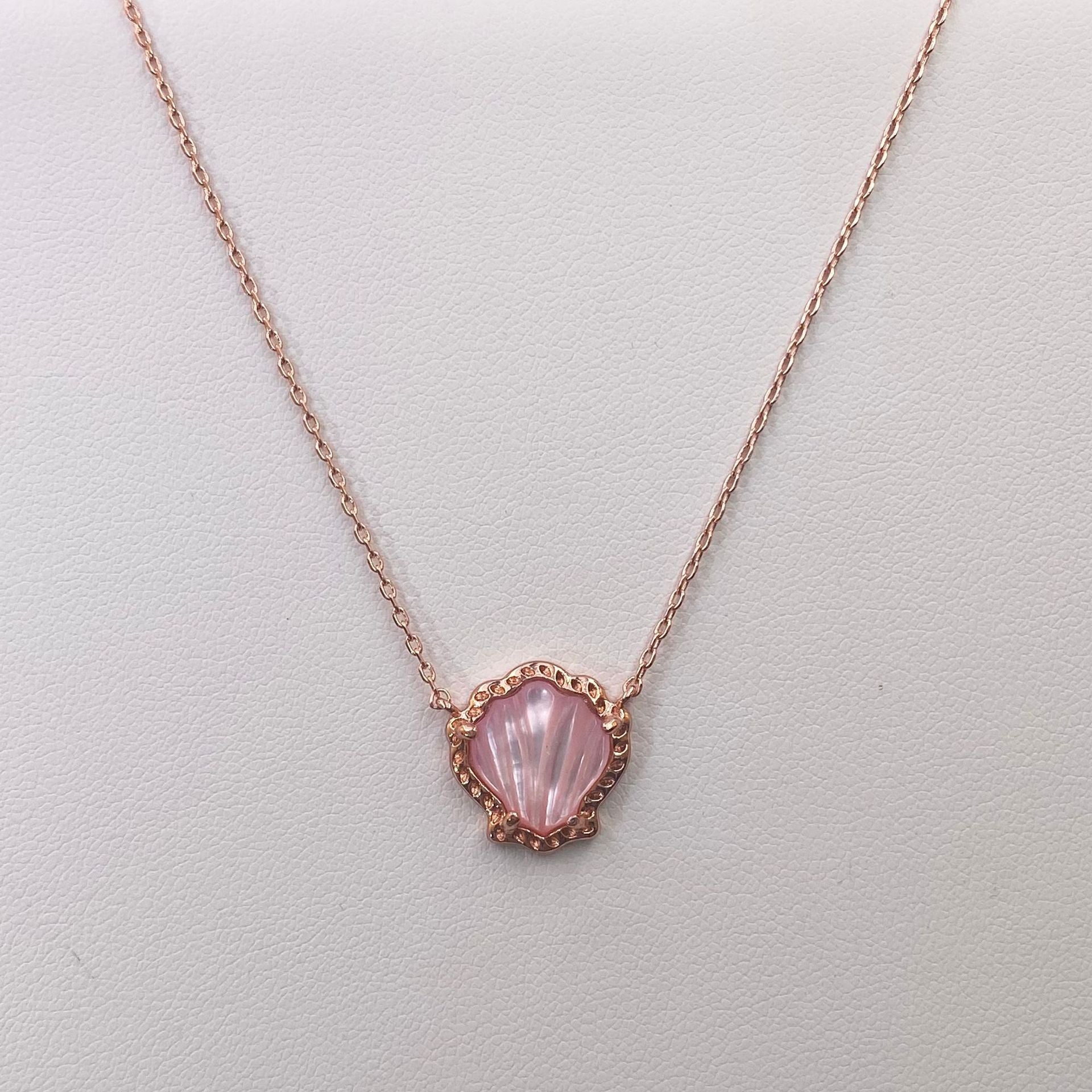 Rose gold-tone scallop pendant necklace with pink mother-of-pearl shell center