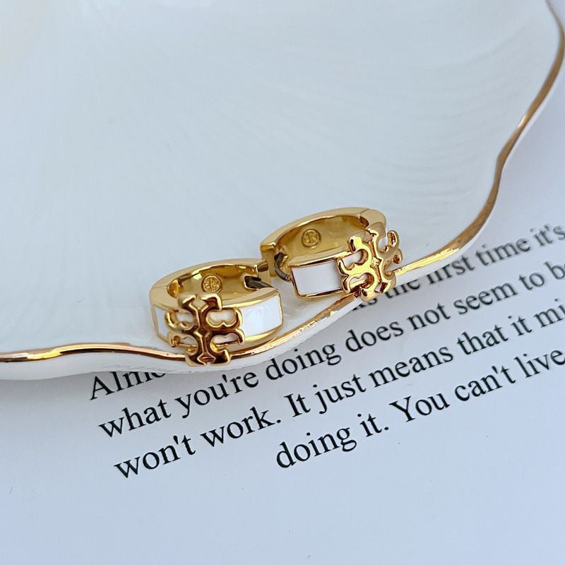 Gold-tone hoop earrings with light enamel logo inset and cutout detail