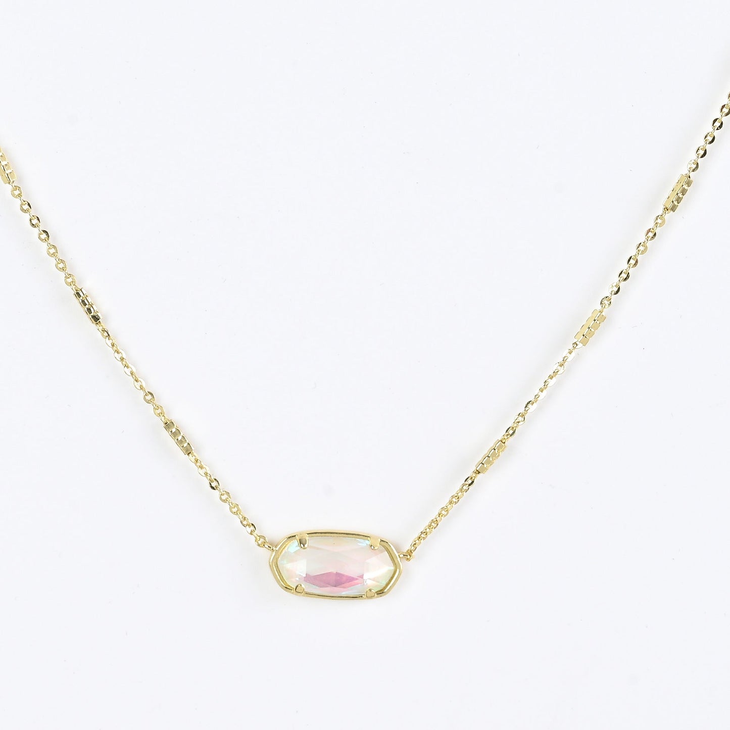 Oval crystal pendant necklace with pale pink stone and gold bezel on a gold chain