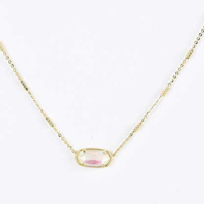Oval crystal pendant necklace with pale pink stone and gold bezel on a gold chain