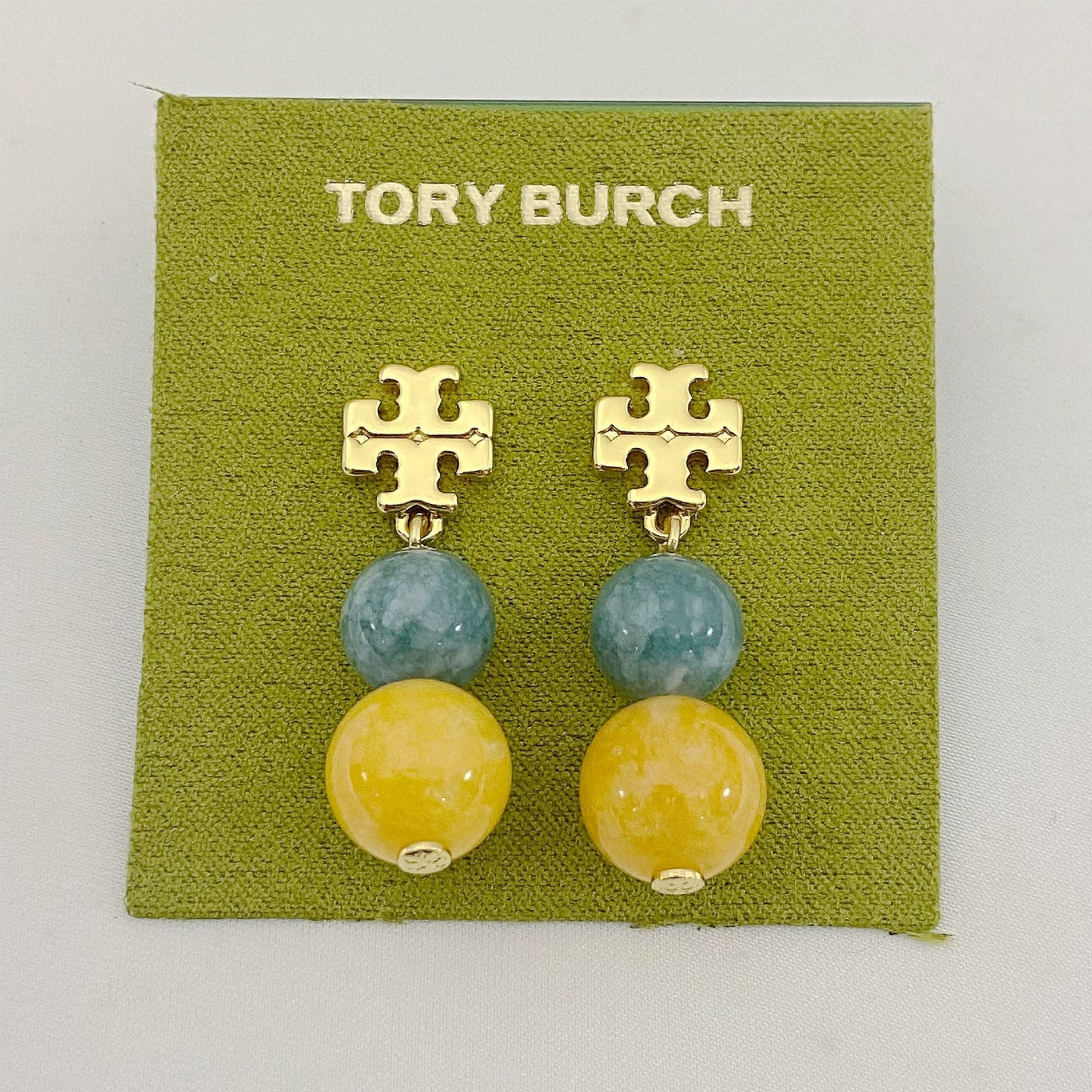 Tory Burch logo pendant earrings with blue and yellow agate beads and gold logo