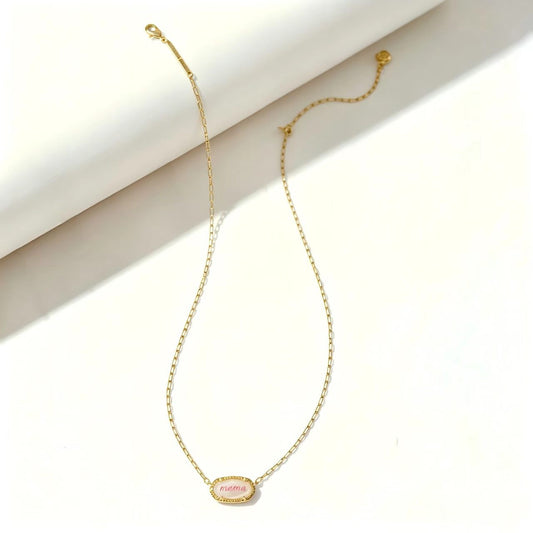 Gold curb-link necklace with oval “mama” pendant charm