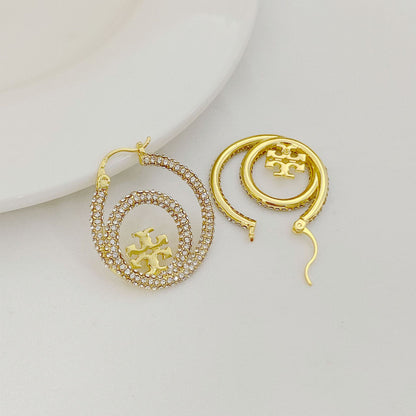 Gold hoop earrings with Tory Burch logo medallion and diamond pavé hoop detail