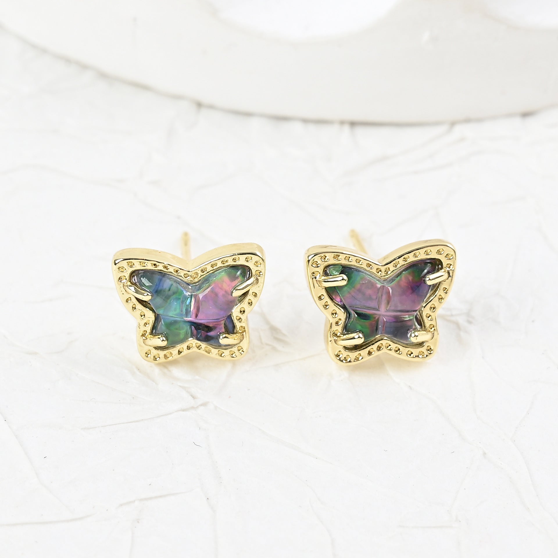 Gold butterfly stud earrings with iridescent multi-color stones