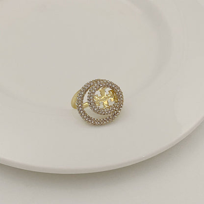 Gold-tone round ring with micro-paved outer band and gold filigree star centerpiece.