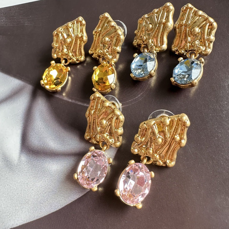 Gold-tone crystal drop earrings with yellow, blue, and pink oval stones