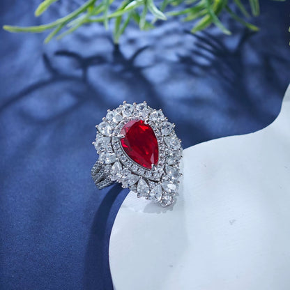 Sterling silver ruby teardrop ring with diamond halo, oval center stone