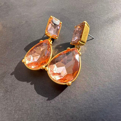 Gold teardrop-cut stud earrings with peach-orange teardrop and square stones