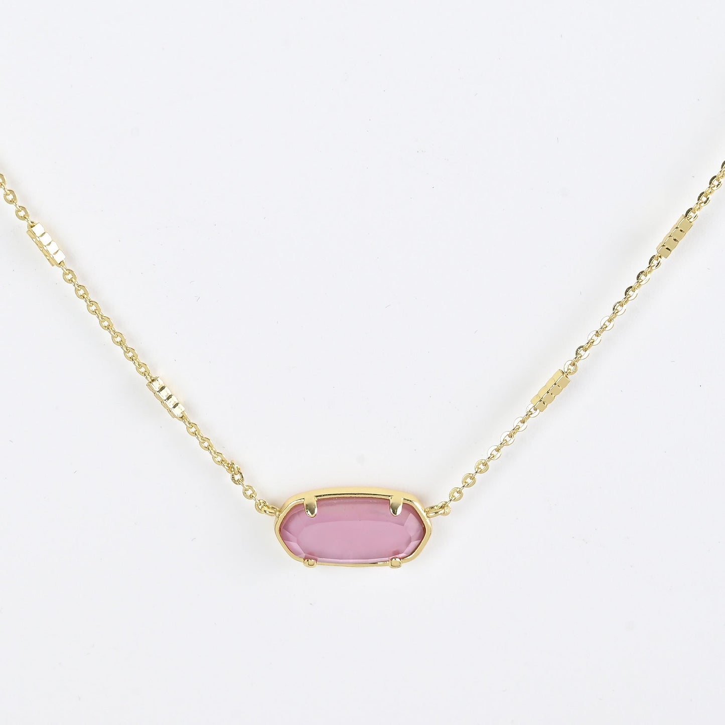Oval crystal pendant necklace with rose pink stone and gold bezel on a gold chain