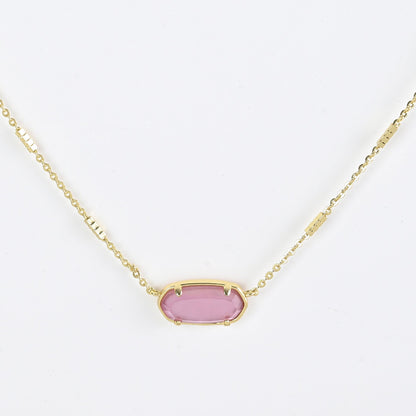 Oval crystal pendant necklace with rose pink stone and gold bezel on a gold chain