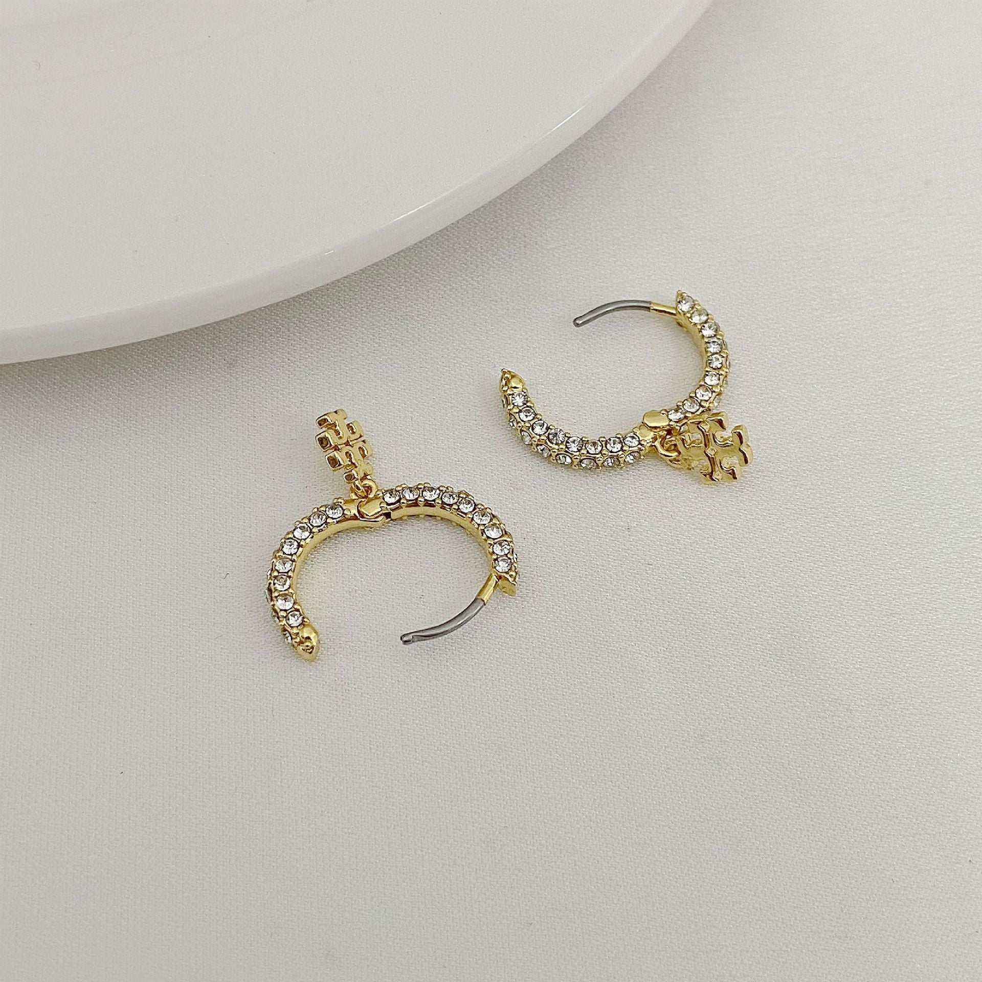 Gold-tone rhinestone C-hoop earrings with pearl beads and dangling charm