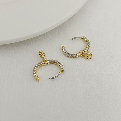 Gold-tone rhinestone C-hoop earrings with pearl beads and dangling charm