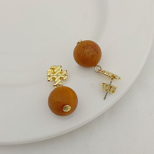 Tory Burch logo beaded pendant earrings, amber round beads, gold tone hardware