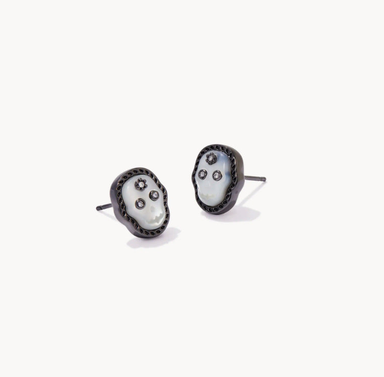 Black stud earrings with white skull faces and small clear gem accents