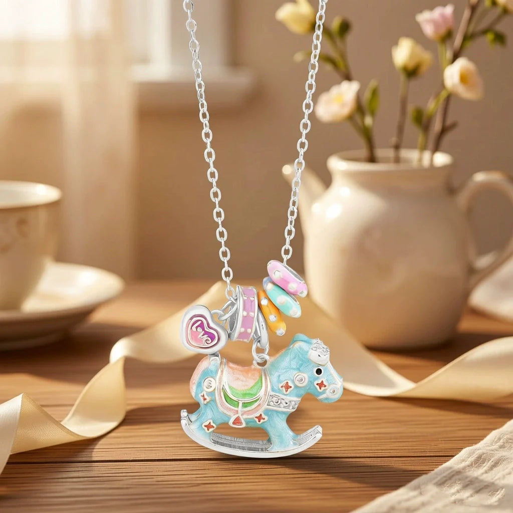 Enamel rocking horse necklace, blue horse charm with heart clasp and purple accent on silver chain