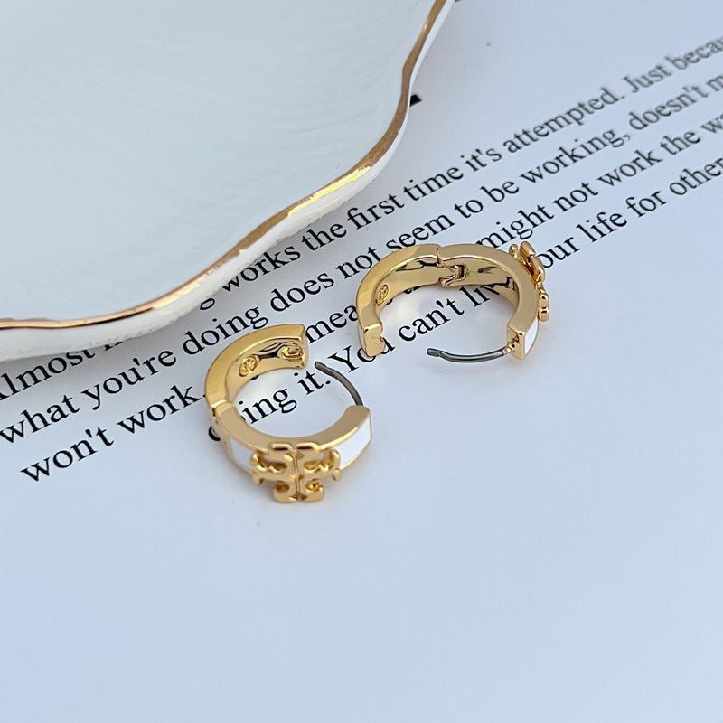 Gold-tone hoop earrings with pink enamel logo detail