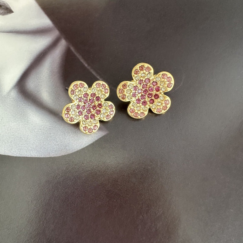 Gold-tone floral stud earrings with pink and purple rhinestones