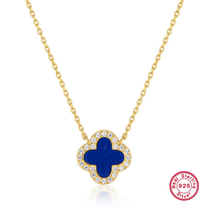 Gold-tone clover pendant with blue center stone and white rhinestone frame