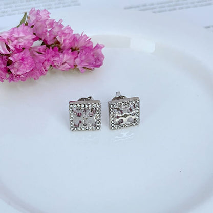 Silver-tone square rhinestone openwork stud earrings with ornate cutout center