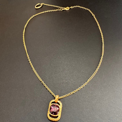 Gold chain square pendant necklace with hammered texture and pink faceted gem