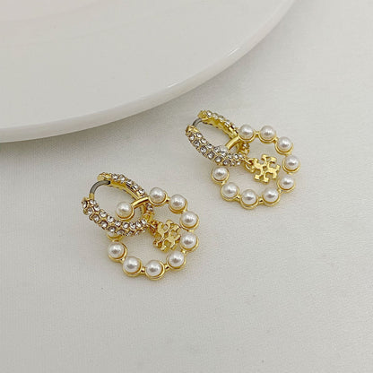 Gold-tone pearl and rhinestone hoop earrings with small charm drops
