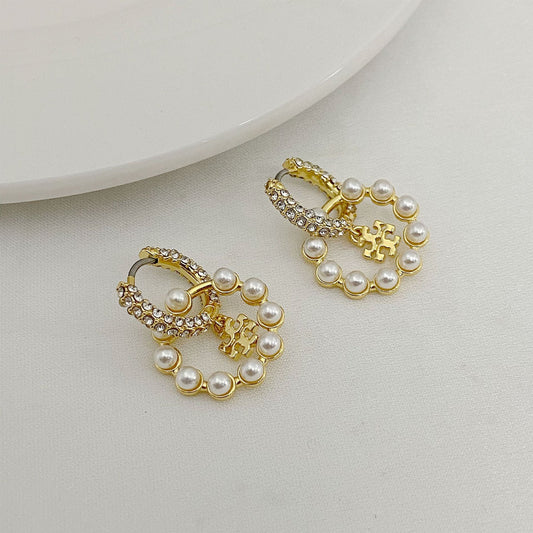 Gold-tone pearl and rhinestone hoop earrings with small charm drops