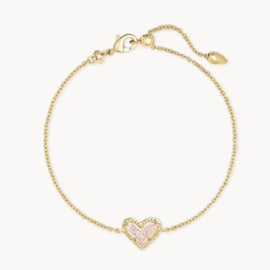 Adjustable heart charm bracelet with gold-tone chain and pink crystal heart centerpiece.