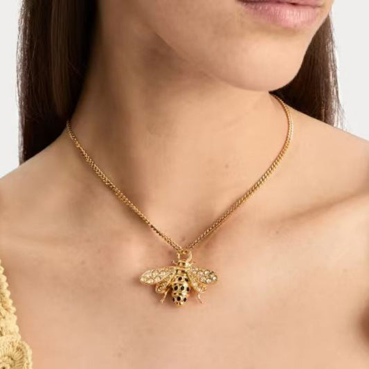 Bee pendant necklace in gold with sparkling accents and stone-studded wings on chain